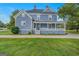 Charming two-story blue home featuring a welcoming front porch and well-maintained lawn at 29 Indian Creek Rd, Locust Grove, GA 30248