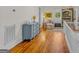 Hallway featuring hardwood floors, blue cabinet, and stairway at 29 Indian Creek Rd, Locust Grove, GA 30248