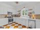 Bright kitchen with white cabinets, open shelves, stainless steel appliances, and patterned floor at 29 Indian Creek Rd, Locust Grove, GA 30248