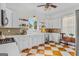 Bright kitchen with white cabinets, open shelves, stainless steel appliances, and patterned floor at 29 Indian Creek Rd, Locust Grove, GA 30248
