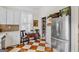 Bright kitchen with white cabinets, stainless steel refrigerator, and patterned floor at 29 Indian Creek Rd, Locust Grove, GA 30248