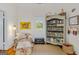 Cozy living room featuring a bookshelf, floral armchair, and natural light at 29 Indian Creek Rd, Locust Grove, GA 30248