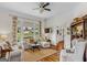 Bright living room with hardwood floors, comfortable seating, and large windows overlooking the yard at 29 Indian Creek Rd, Locust Grove, GA 30248