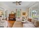 Inviting living room features hardwood floors, neutral sofas, and large windows for natural light at 29 Indian Creek Rd, Locust Grove, GA 30248