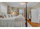 Cozy bedroom with a four-poster bed, hardwood floors, and natural light at 29 Indian Creek Rd, Locust Grove, GA 30248