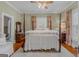 Inviting bedroom with four-poster bed, hardwood floors, and decorative touches at 29 Indian Creek Rd, Locust Grove, GA 30248
