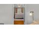 View through doorway of four-poster bed, hardwood floors, and natural light at 29 Indian Creek Rd, Locust Grove, GA 30248