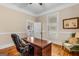 Bright home office features a wooden desk, hardwood floors, and natural light at 29 Indian Creek Rd, Locust Grove, GA 30248
