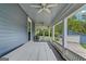 Covered porch featuring a ceiling fan, outdoor furniture, and a view of the backyard and garage at 29 Indian Creek Rd, Locust Grove, GA 30248