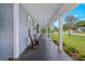 Side porch with rocking chairs, offering an unobstructed view of the well manicured front yard at 29 Indian Creek Rd, Locust Grove, GA 30248