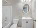 Bathroom featuring a white vanity, round mirror, toilet, and shower and tub at 35 Wenham Ln, Sharpsburg, GA 30277