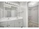 Bathroom has a double sink vanity, large mirror and leads to a walk in closet at 35 Wenham Ln, Sharpsburg, GA 30277
