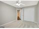 A carpeted bedroom features a ceiling fan, closet, and a glimpse of the adjacent bathroom at 35 Wenham Ln, Sharpsburg, GA 30277