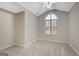 Bright bedroom with vaulted ceiling, ceiling fan, arch window and neutral carpet and paint at 35 Wenham Ln, Sharpsburg, GA 30277