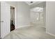 Large carpeted room with neutral paint, ceiling fan, and door leading to the outside at 35 Wenham Ln, Sharpsburg, GA 30277