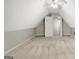 A carpeted bonus room with angled ceilings features a door offering versatile use at 35 Wenham Ln, Sharpsburg, GA 30277