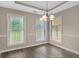 Dining room with large windows, chandelier, and neutral walls at 35 Wenham Ln, Sharpsburg, GA 30277