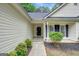 Welcoming entrance with a view of the manicured landscape and cozy charm at 35 Wenham Ln, Sharpsburg, GA 30277