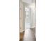 Hallway with gray floors showing room with vaulted ceiling and arch window at 35 Wenham Ln, Sharpsburg, GA 30277