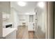 Bright kitchen with wood flooring, stainless steel refrigerator and views into adjacent rooms at 35 Wenham Ln, Sharpsburg, GA 30277