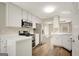 Bright kitchen featuring white cabinets, stainless steel appliances, and hardwood flooring at 35 Wenham Ln, Sharpsburg, GA 30277
