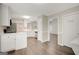 Spacious kitchen with stainless steel appliances and wooden floors plus access to laundry room at 35 Wenham Ln, Sharpsburg, GA 30277