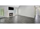 Bright living room features fireplace, TV, door to the outside, gray floors and neutral paint at 35 Wenham Ln, Sharpsburg, GA 30277