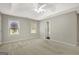 Main bedroom has neutral walls, carpet, ceiling fan, and two windows to let in natural light at 35 Wenham Ln, Sharpsburg, GA 30277