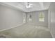 Main bedroom has neutral walls, carpet, ceiling fan, and two windows to let in natural light at 35 Wenham Ln, Sharpsburg, GA 30277
