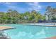 A refreshing community pool surrounded by lounge chairs and lush trees, perfect for summer relaxation at 35 Wenham Ln, Sharpsburg, GA 30277