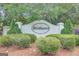 The Strathmore community sign is surrounded by lush greenery and landscaping creating a welcoming entrance at 35 Wenham Ln, Sharpsburg, GA 30277