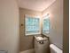 Bathroom featuring a vanity with a granite countertop and a window at 830 Mercury Dr, Atlanta, GA 30331