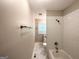 Bathroom features a shower and bathtub combo with subway tile and marble tile flooring at 830 Mercury, Atlanta, GA 30331