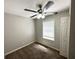 Cozy bedroom featuring carpeted floors, a ceiling fan, and natural light at 830 Mercury Dr, Atlanta, GA 30331