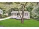 Charming one-story home with black shutters, green lawn and mature trees at 830 Mercury Dr, Atlanta, GA 30331