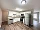 Updated kitchen with stainless steel appliances, granite counters, and white cabinets at 830 Mercury Dr, Atlanta, GA 30331