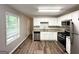 Updated kitchen featuring stainless steel appliances, granite counters, and white cabinets at 830 Mercury Dr, Atlanta, GA 30331
