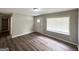 Living room showcasing wood-look flooring, large window, and neutral paint at 830 Mercury Dr, Atlanta, GA 30331