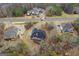 A high-angle aerial view of home showing a deck, lush landscape, and surrounding homes at 1442 Swiftwater Cir, Mcdonough, GA 30252