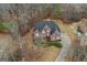 Stunning aerial view of a brick two-story home, showcasing its landscaped yard and long driveway at 1442 Swiftwater Cir, Mcdonough, GA 30252
