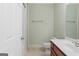 Cozy bathroom with tile floor, wood vanity, toilet, and a shower behind a curtain at 1442 Swiftwater Cir, Mcdonough, GA 30252