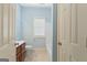 Clean and bright bathroom featuring tile floor, vanity, toilet, and a shower behind a curtain at 1442 Swiftwater Cir, Mcdonough, GA 30252