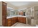 A luxurious primary bath boasts double vanities, a shower and tile floors, a blend of luxury and functionality at 1442 Swiftwater Cir, Mcdonough, GA 30252