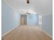 Large bedroom with blue walls, neutral carpet, and a ceiling fan for optimal comfort at 1442 Swiftwater Cir, Mcdonough, GA 30252