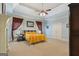 Large main bedroom with blue walls, ceiling fan, and carpet floors at 1442 Swiftwater Cir, Mcdonough, GA 30252