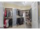 Spacious walk-in closet with custom shelving and ample storage space for clothes and accessories at 1442 Swiftwater Cir, Mcdonough, GA 30252