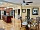 Bright dining area adjacent to the kitchen, boasting a glass table, ornate chairs and a ceiling fan at 1442 Swiftwater Cir, Mcdonough, GA 30252
