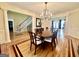 Elegant dining room featuring hardwood floors, chandelier, and access to other living spaces at 1442 Swiftwater Cir, Mcdonough, GA 30252