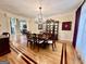 A formal dining area with hardwood floors, a chandelier, and beautiful moldings and trim at 1442 Swiftwater Cir, Mcdonough, GA 30252