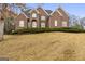 Charming two-story brick home with a well-maintained lawn and mature trees at 1442 Swiftwater Cir, Mcdonough, GA 30252